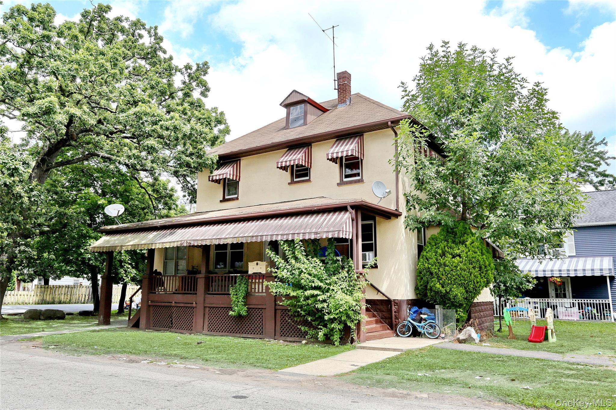 Undisclosed Address Spring Valley, NY 10977 - Photo 2 of 9 a front view of a house with a yard