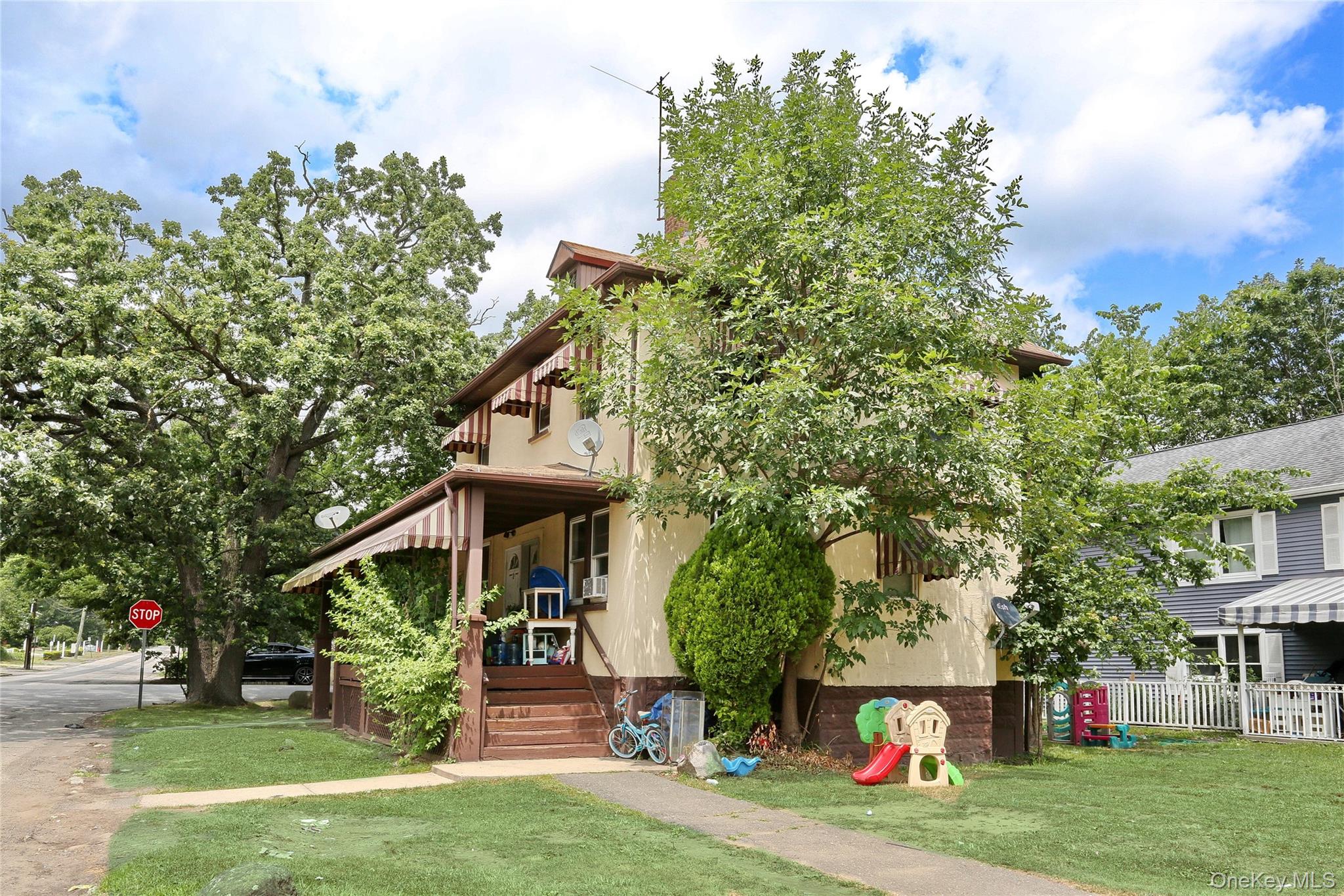 Undisclosed Address Spring Valley, NY 10977 - Photo 4 of 9 a front view of a house with garden