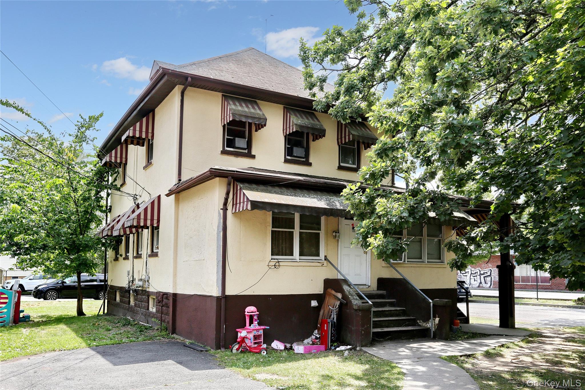 Undisclosed Address Spring Valley, NY 10977 - Photo 7 of 9 a front view of a house with a yard