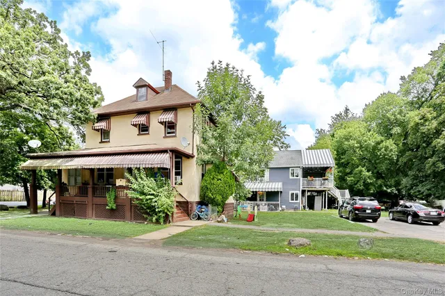 a front view of a house with a yard and table and chairs