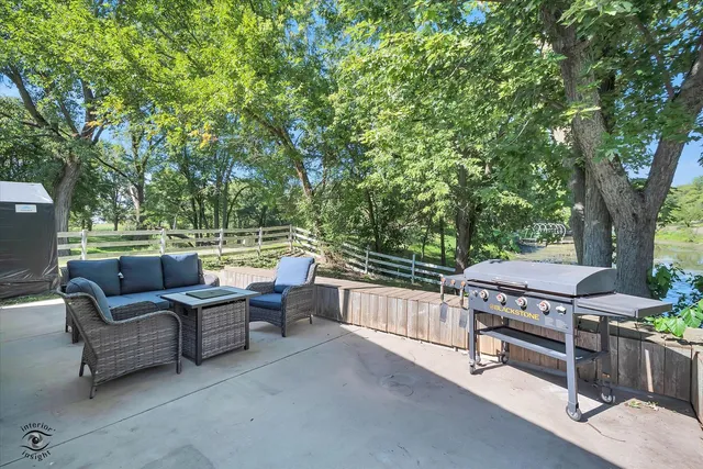 a view of a patio with furniture and a backyard