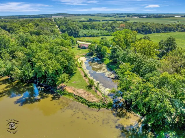 a view of a lush green forest with a lake and mountain view