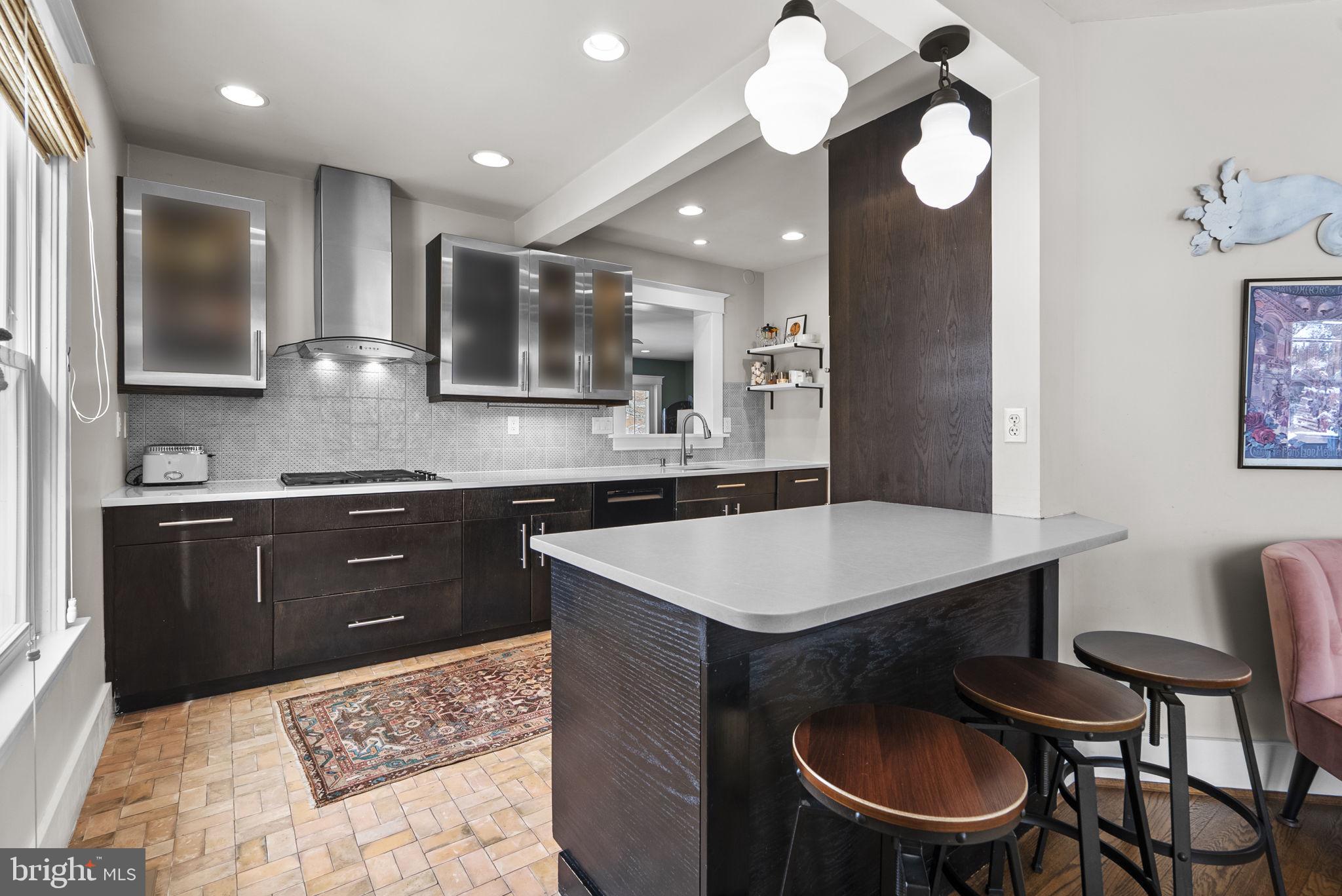 1415 Ballard Street Silver Spring, MD 20910 - Photo 12 of 56 a kitchen with a table chairs sink and cabinets