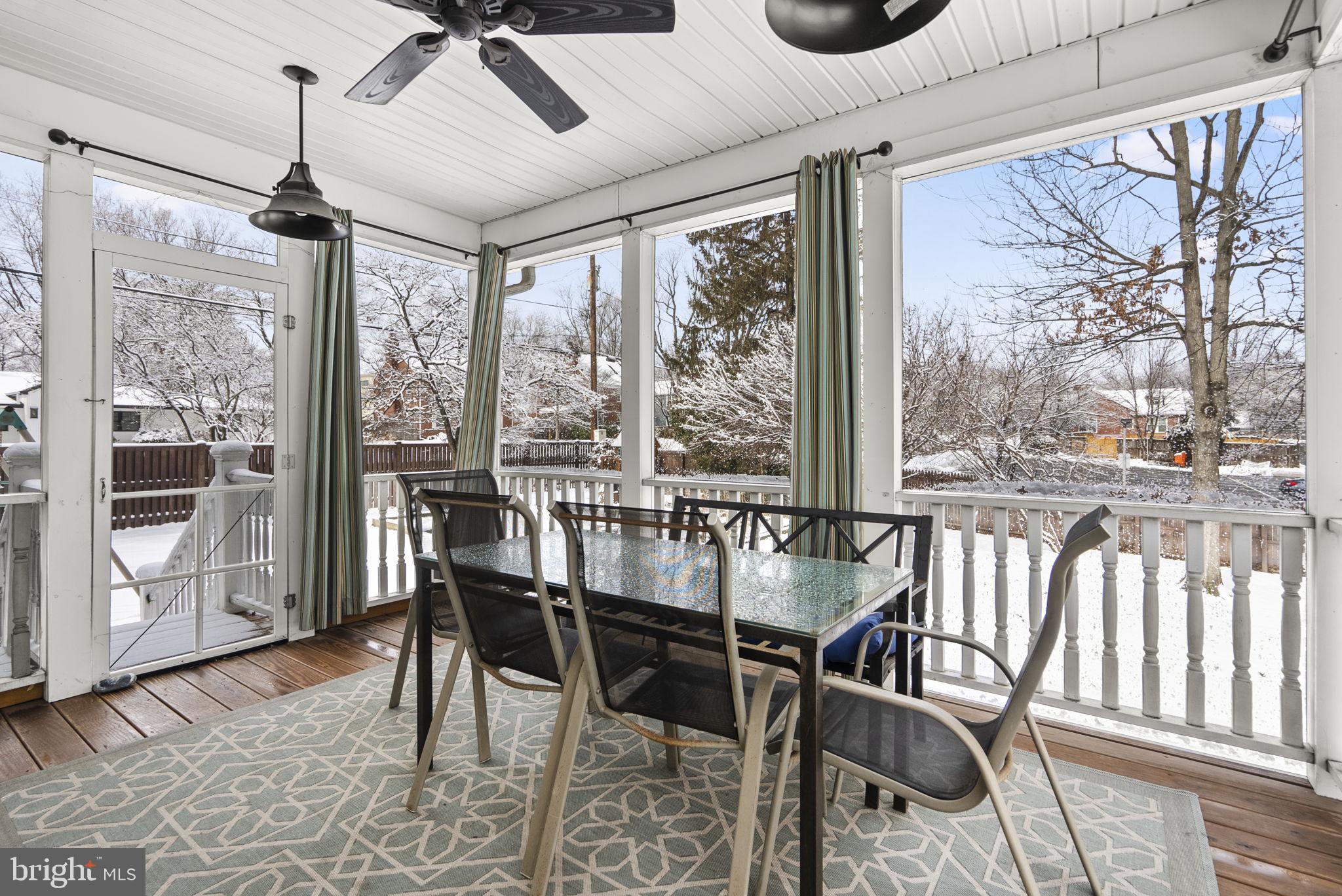 1415 Ballard Street Silver Spring, MD 20910 - Photo 27 of 56 a view of a dining room with furniture large windows and wooden floor