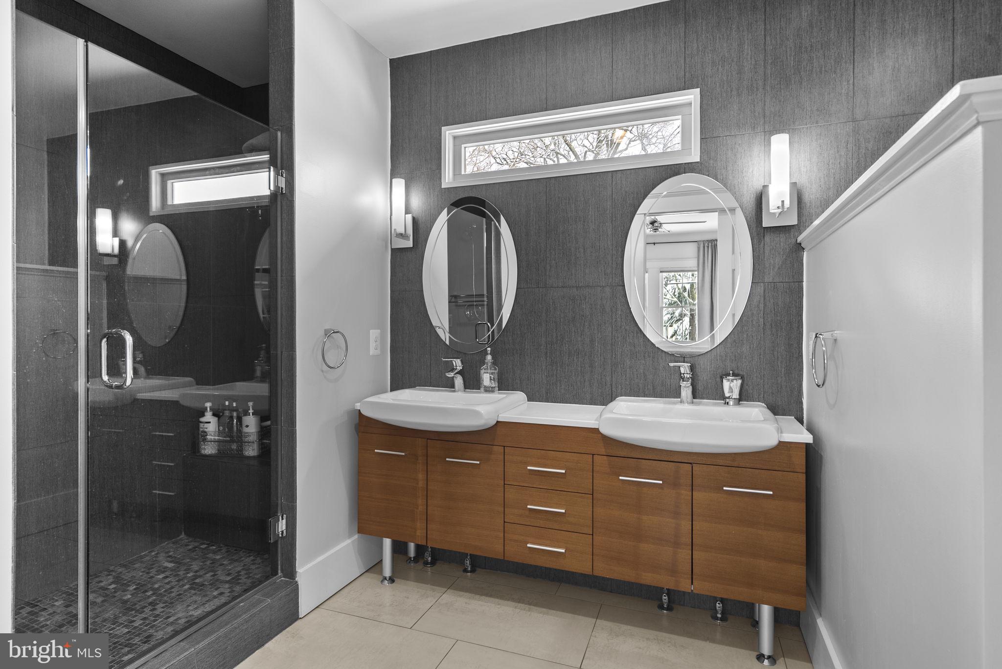 1415 Ballard Street Silver Spring, MD 20910 - Photo 39 of 56 a bathroom with a double vanity sink mirror and shower