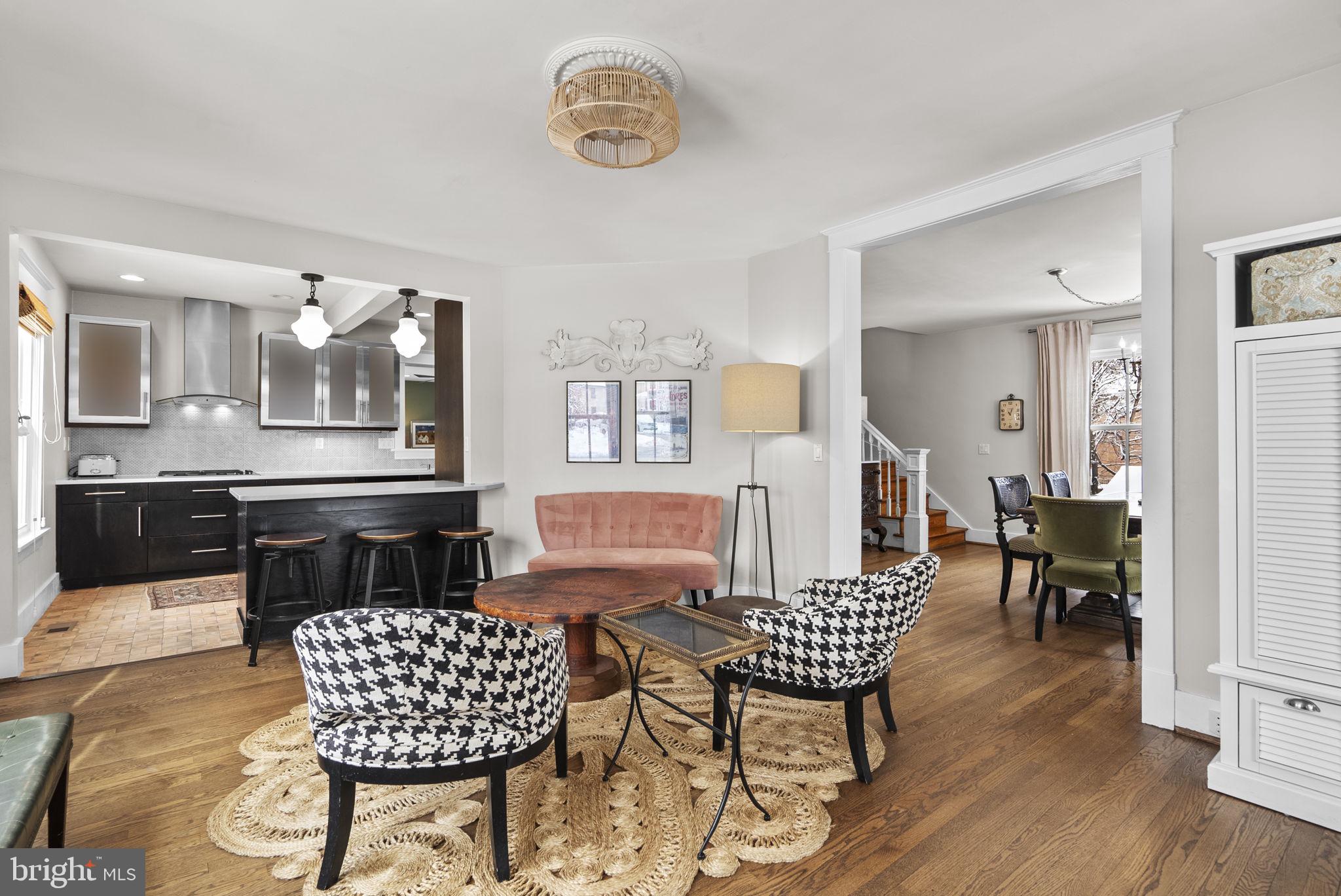 1415 Ballard Street Silver Spring, MD 20910 - Photo 10 of 56 a living room with furniture a dining table and paintings on the wall
