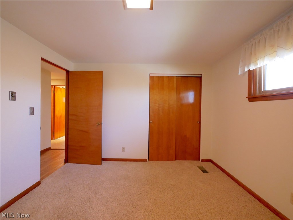 57500 Hospital Road Bellaire, OH 43906 - Photo 11 of 22 Unfurnished bedroom featuring a closet and light carpet