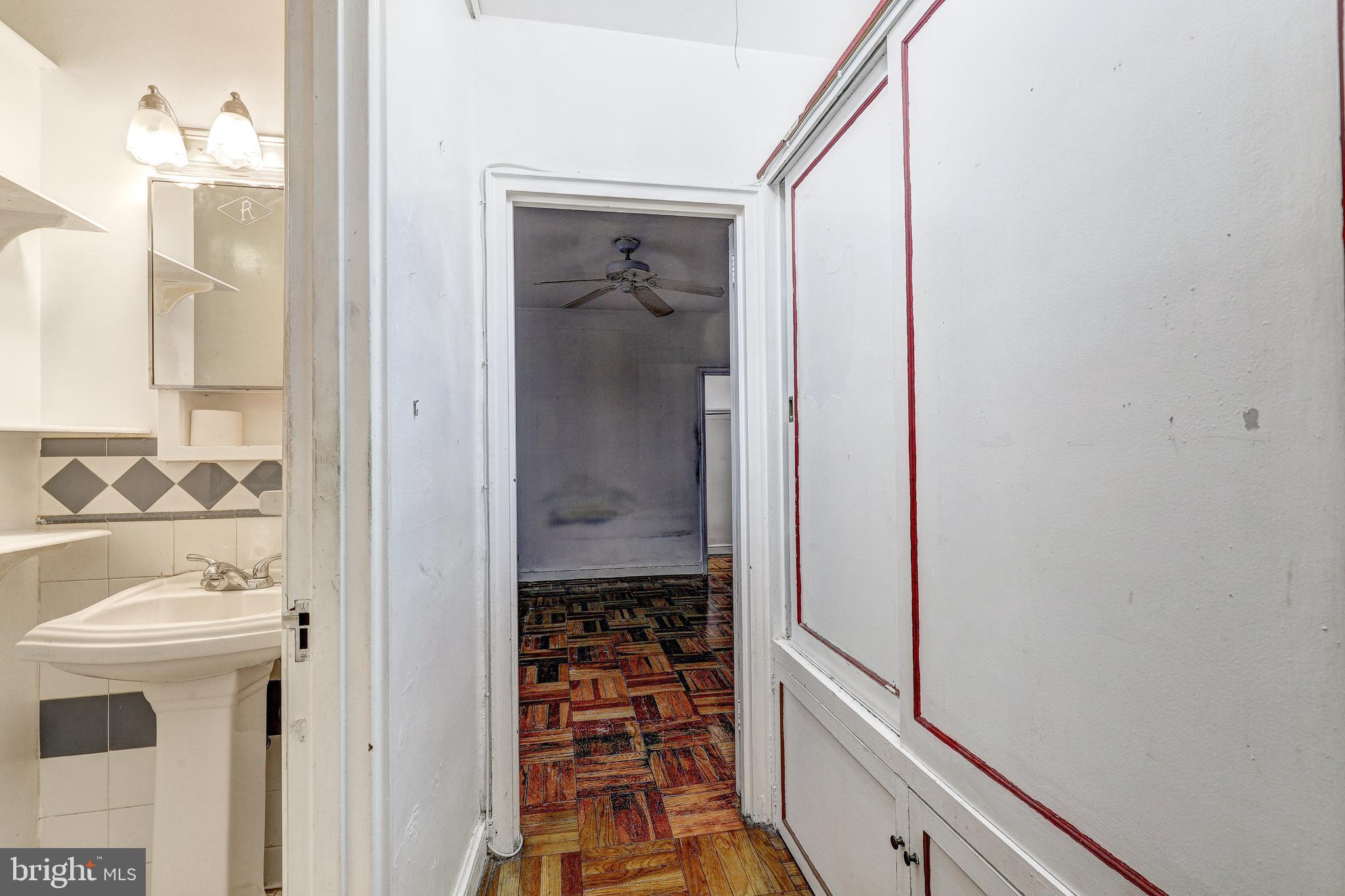 221 Ridgemede Road, Unit 303 Baltimore, MD 21210 - Photo 13 of 32 Hallway to bedroom with built-in storage