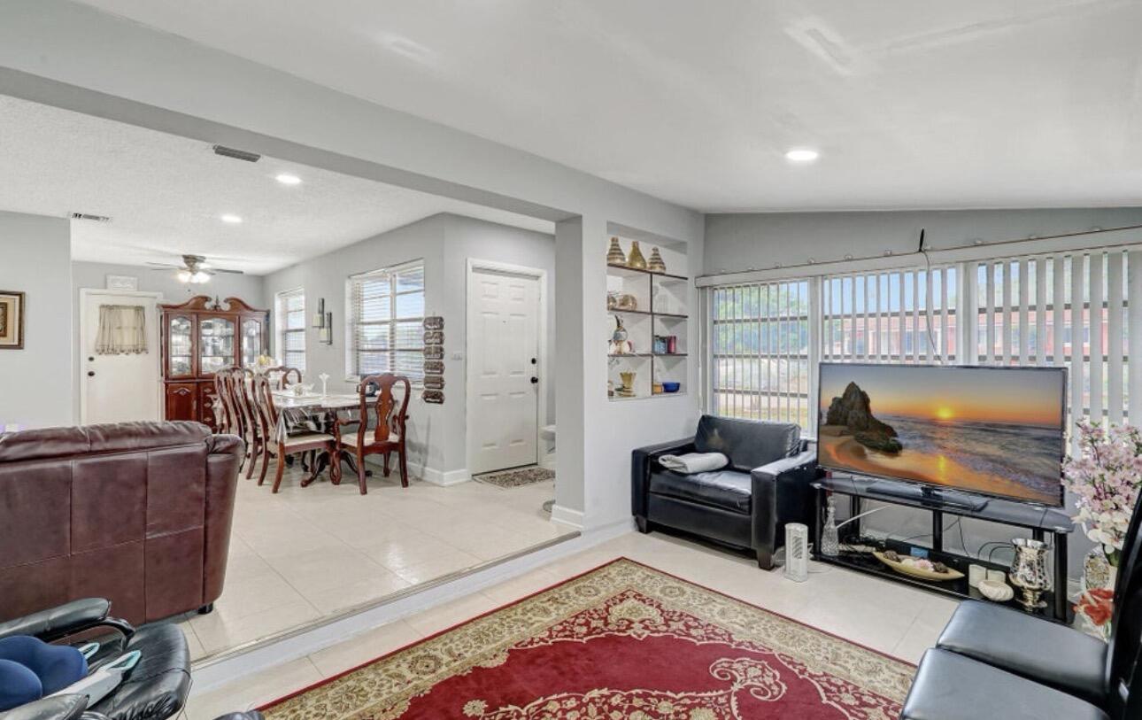 7530 Atlanta Street Hollywood, FL 33024 - Photo 14 of 23 a living room with furniture and a flat screen tv
