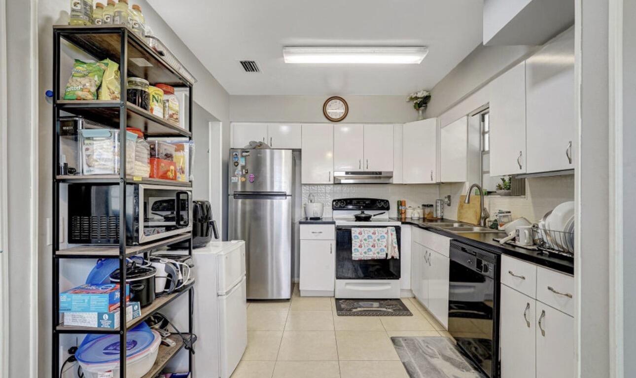 7530 Atlanta Street Hollywood, FL 33024 - Photo 17 of 23 a kitchen with stainless steel appliances granite countertop a refrigerator and a stove top oven