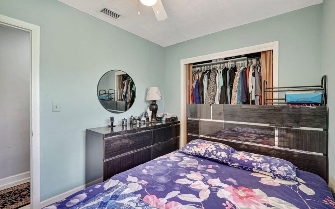 7530 Atlanta Street Hollywood, FL 33024 - Photo 20 of 23 a bedroom with a bed cabinets and painting on the wall