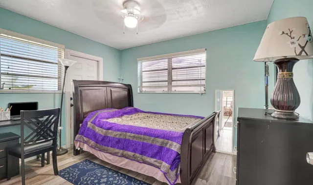 a bedroom with bed and a window