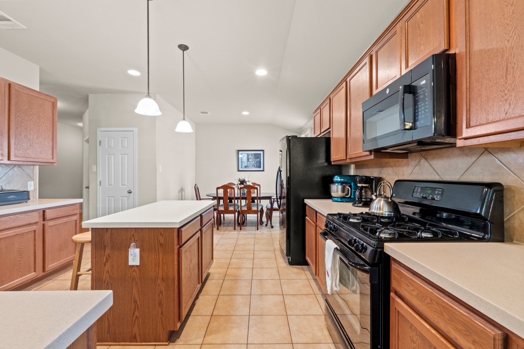 12008 Lansdowne Road Austin, TX 78754 - Photo 13 of 29 A well-equipped culinary space featuring an inviting kitchen island and casual dining area.