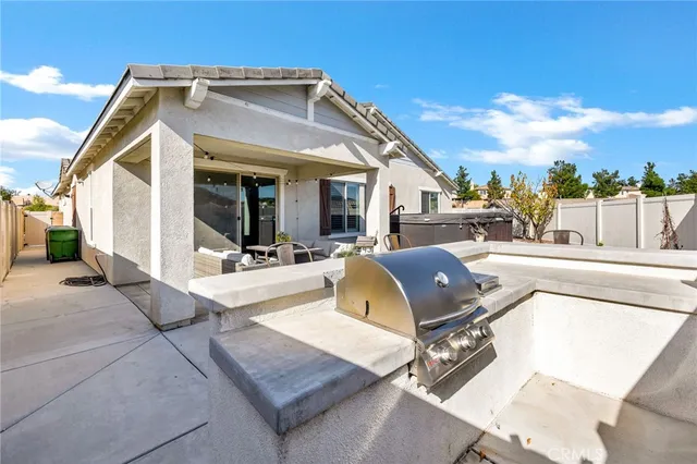 a view of a white house with couches chairs and wooden floor