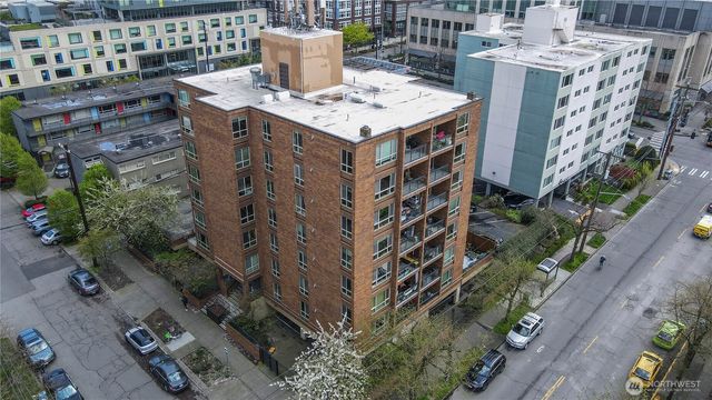 a view of a tall building in the backyard