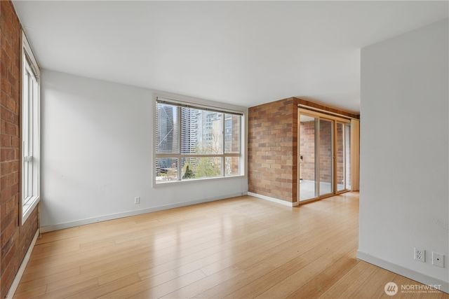 an empty room with windows and closet