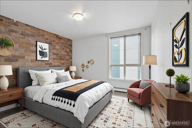 a bedroom with bed and a window