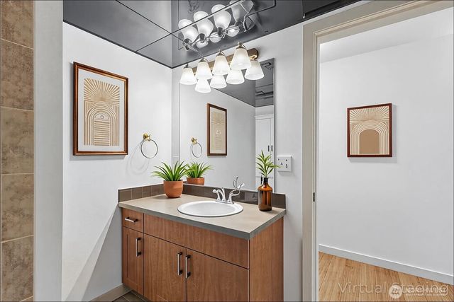 a bathroom with a sink vanity and a mirror