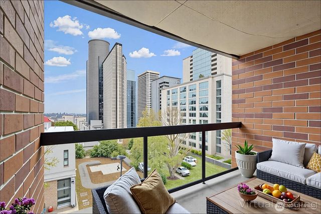 a living room with furniture and a floor to ceiling window