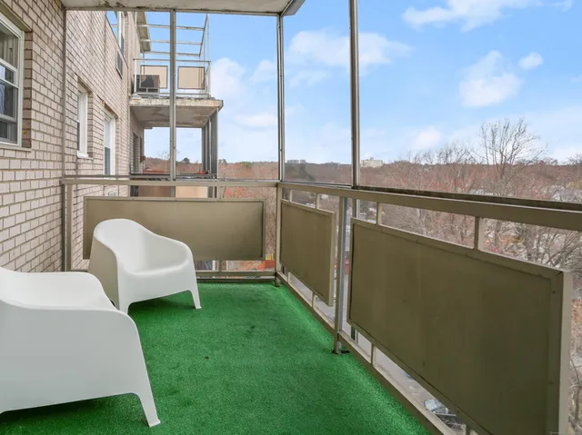 a view of a balcony with chairs