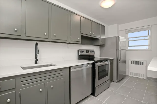 a kitchen with cabinets and appliances