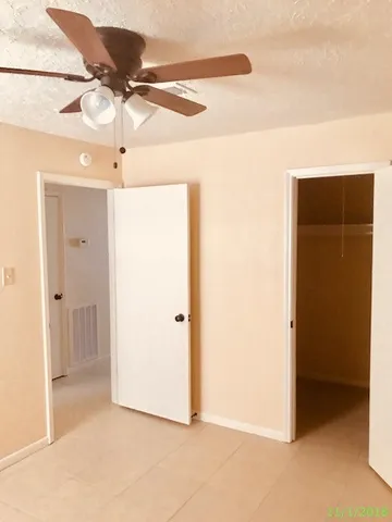a view of a room with a ceiling fan