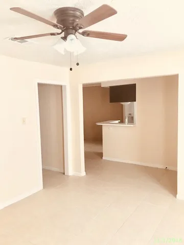 a view of a room with a ceiling fan