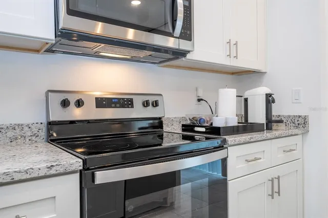 a kitchen with stainless steel appliances granite countertop a sink and cabinets
