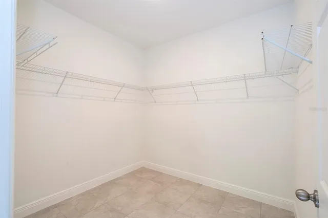 a bathroom with a granite countertop toilet a sink and a mirror