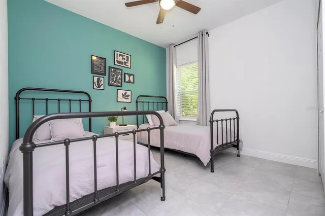 a bedroom with a bed and a window