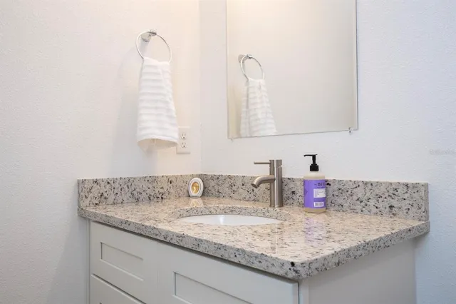 a view of a workspace room with furniture and window