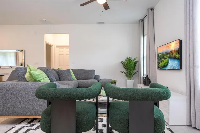 a living room with furniture and a potted plant