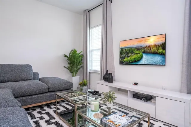 a living room with furniture and a flat screen tv