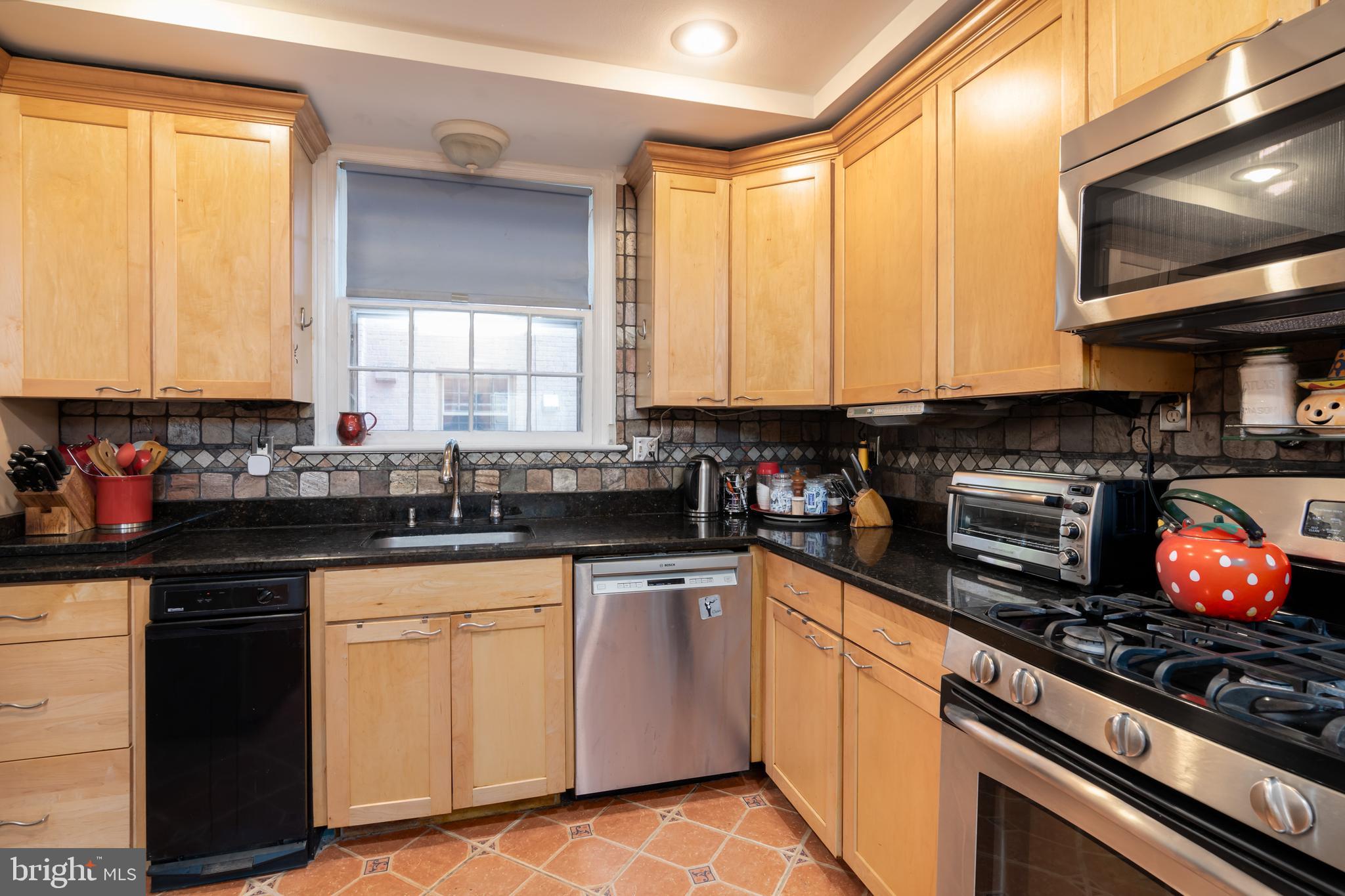 5016 Reno Road Northwest Washington, DC 20008 - Photo 9 of 38 Modern kitchen offers granite & SS appliances.