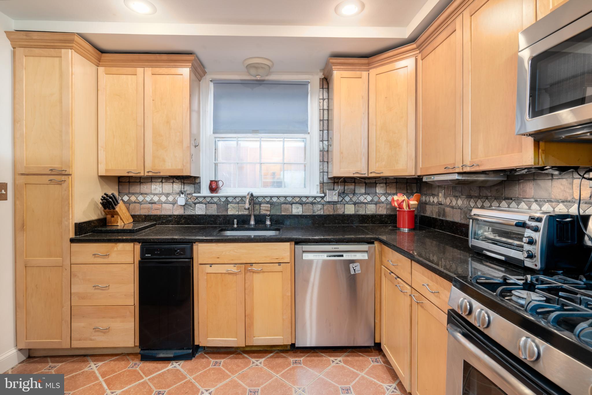 5016 Reno Road Northwest Washington, DC 20008 - Photo 10 of 38 Kitchen boasts abundant custom cabinetry.