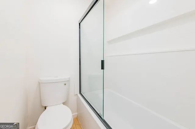 a bathroom with a toilet and a shower