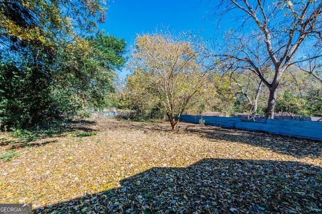 a view of a small house with a yard