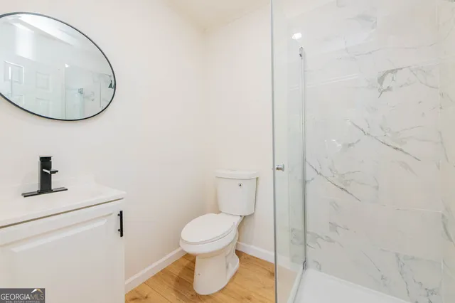 a bathroom with a toilet and a mirror