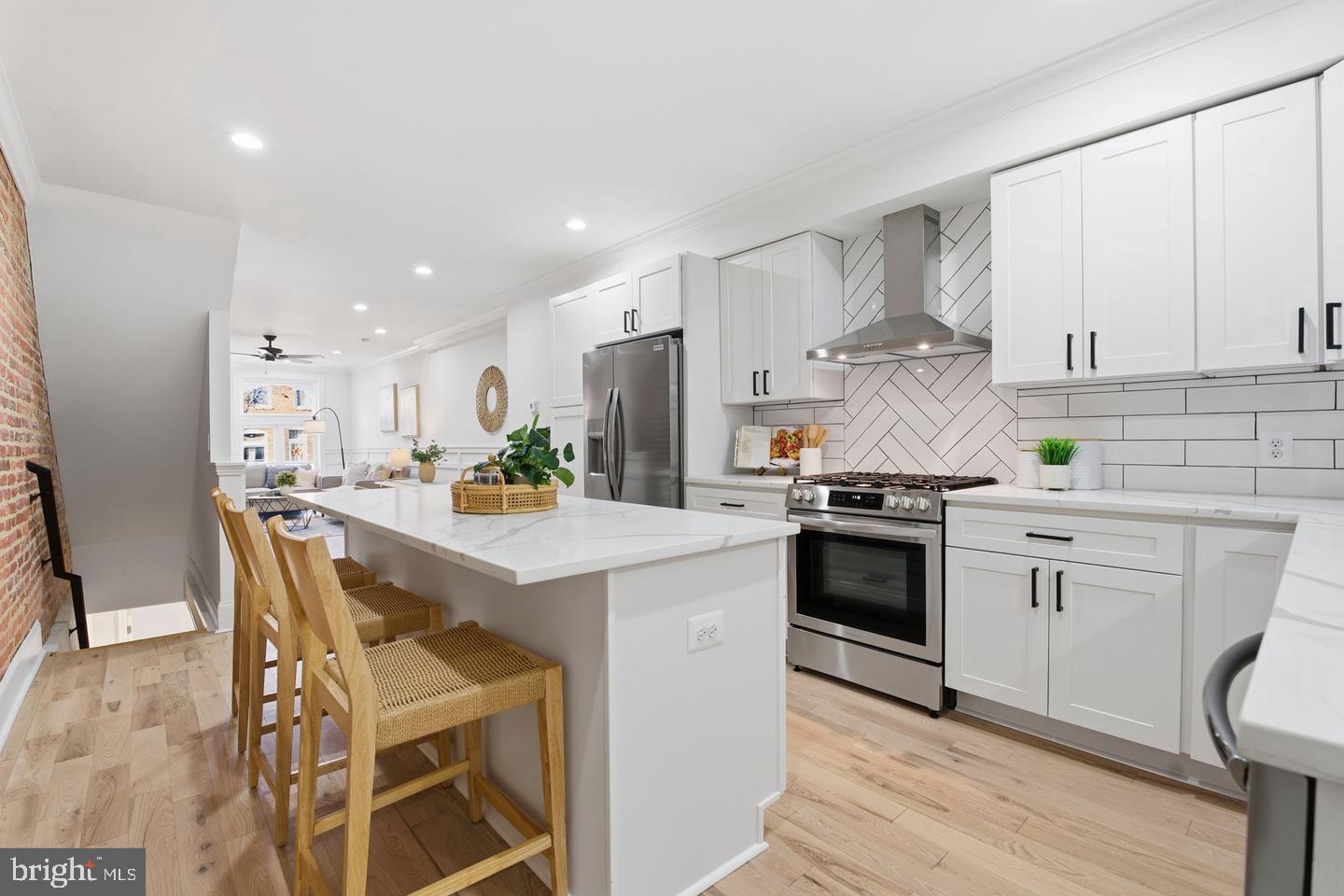808 South Highland Avenue Baltimore, MD 21224 - Photo 3 of 6 a kitchen with white cabinets and white appliances