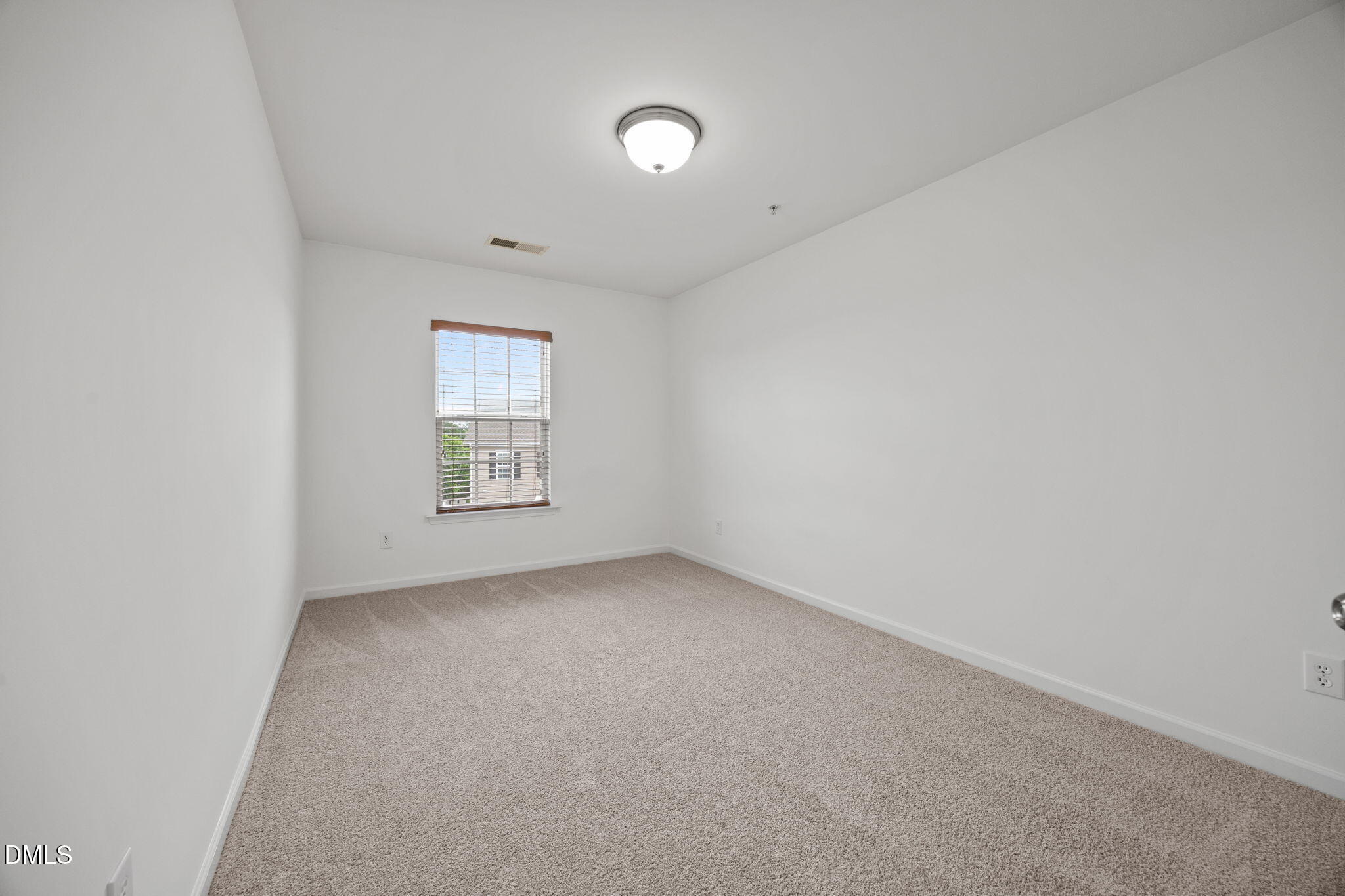 1111 Consortium Drive, Unit 109 Raleigh, NC 27603 - Photo 11 of 30 a view of an empty room with a window
