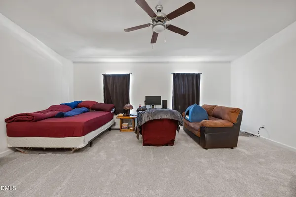 a bedroom with bed and window