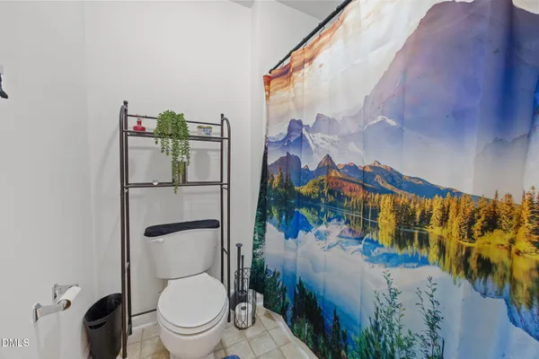 a white toilet sitting next to a bathroom sink