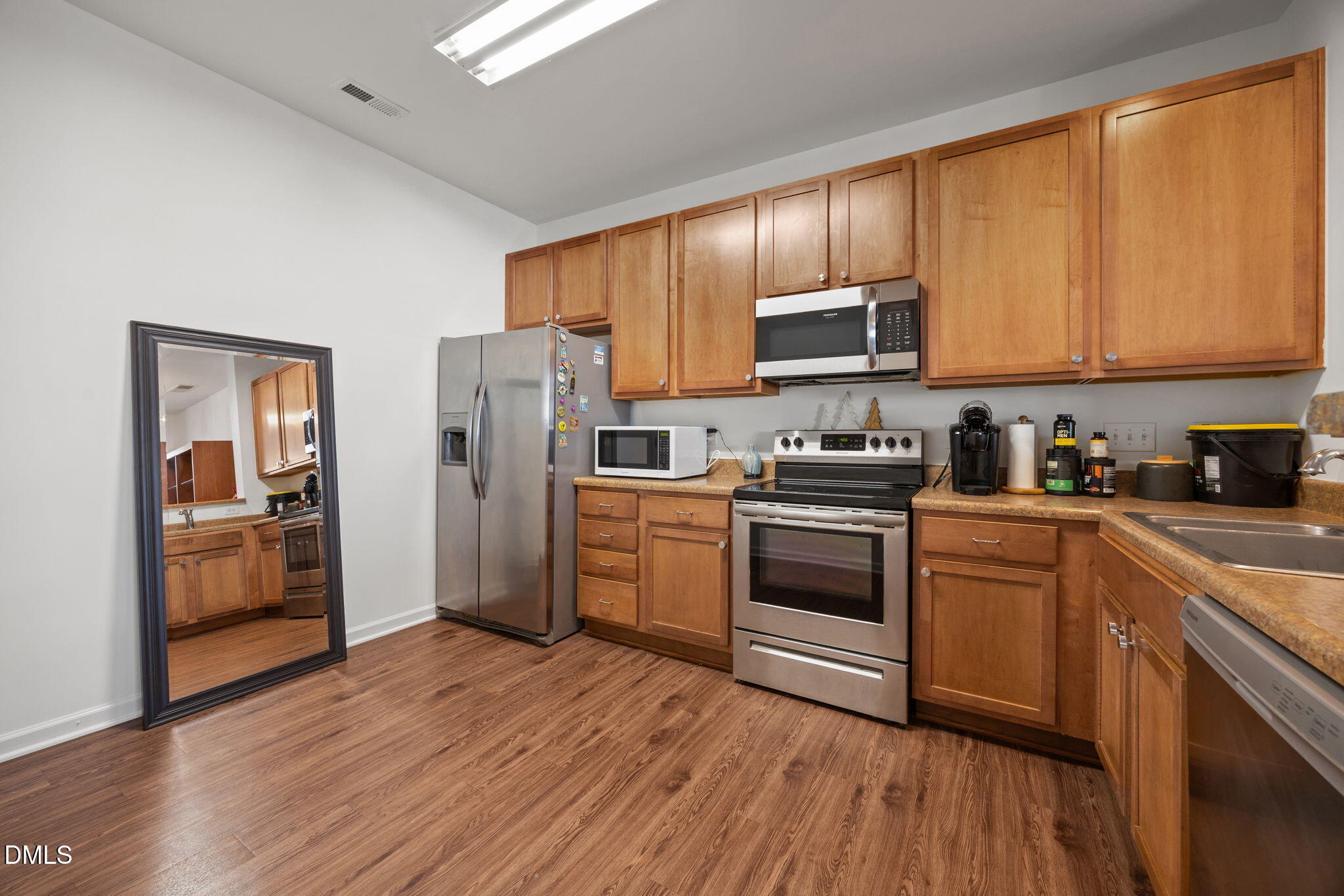 1111 Consortium Drive, Unit 109 Raleigh, NC 27603 - Photo 3 of 30 a kitchen with a refrigerator stove top oven and sink
