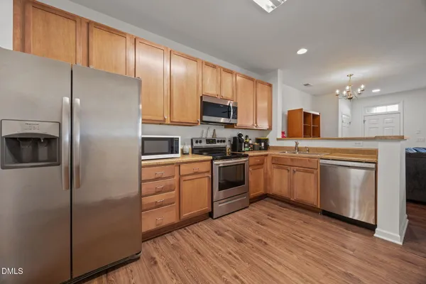 a kitchen with a refrigerator stove top oven and sink