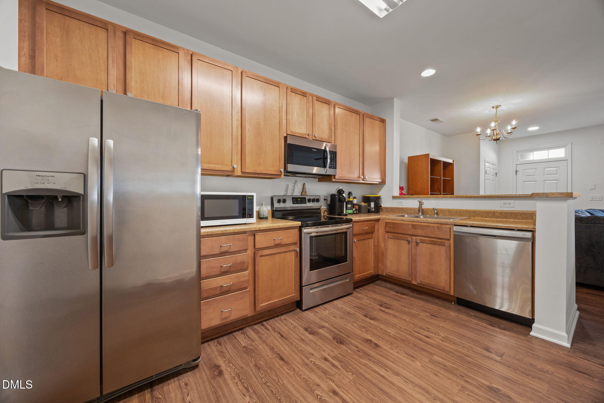 1111 Consortium Drive, Unit 109 Raleigh, NC 27603 - Photo 4 of 30 a kitchen with a refrigerator stove top oven and sink