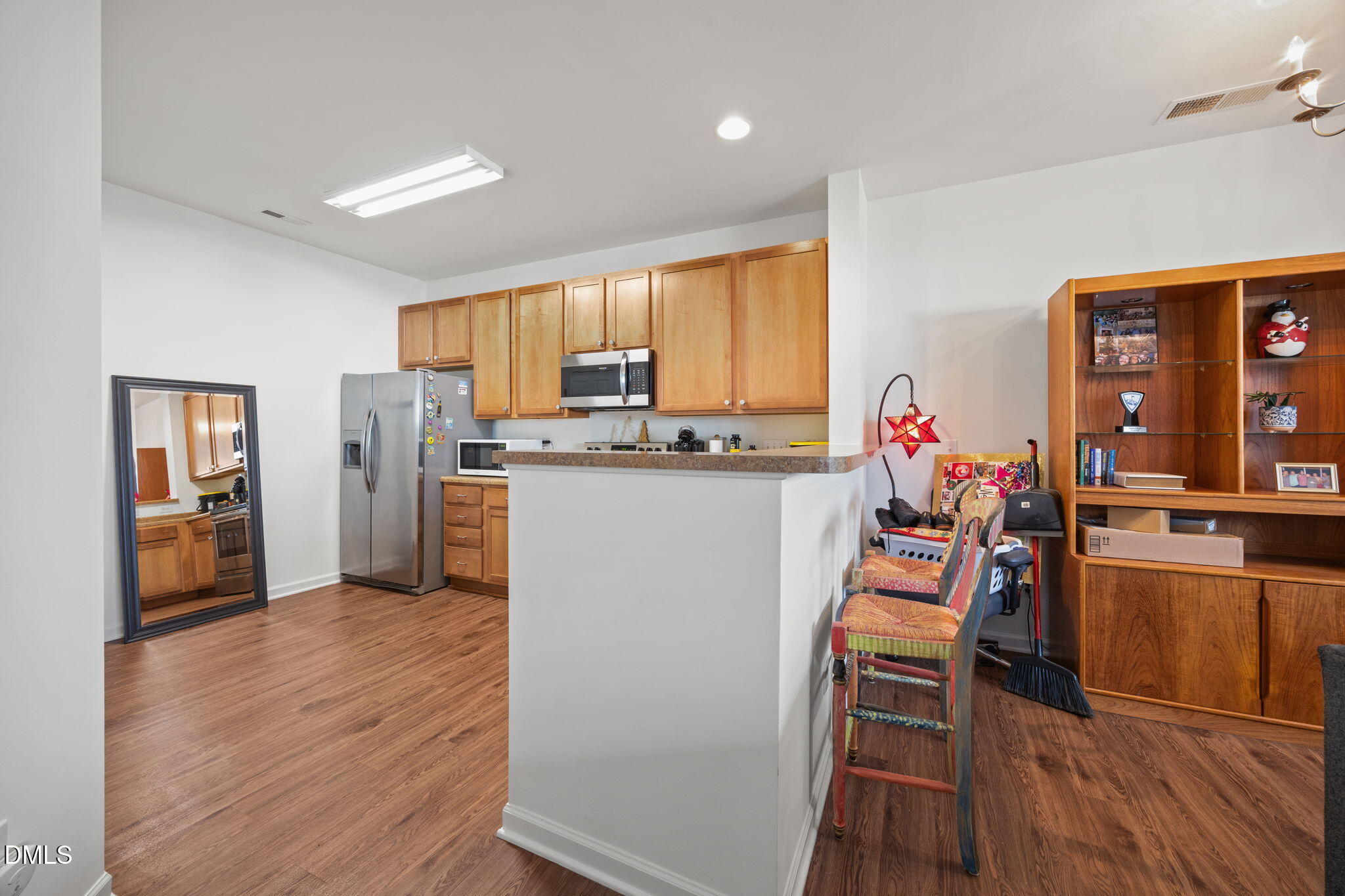 1111 Consortium Drive, Unit 109 Raleigh, NC 27603 - Photo 5 of 30 a dining room filled counter top space and stainless steel appliances