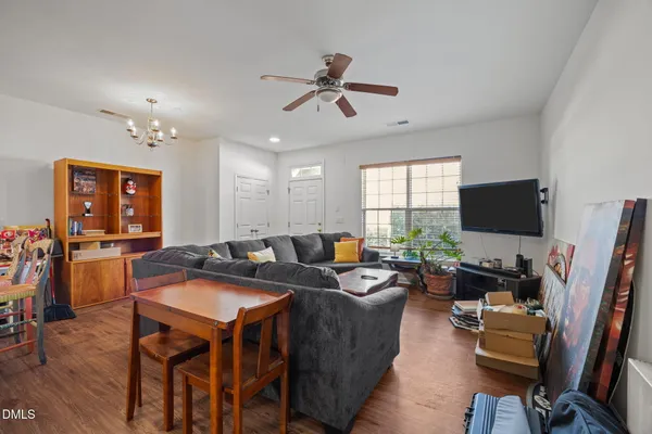 a living room with furniture a flat screen tv and a window