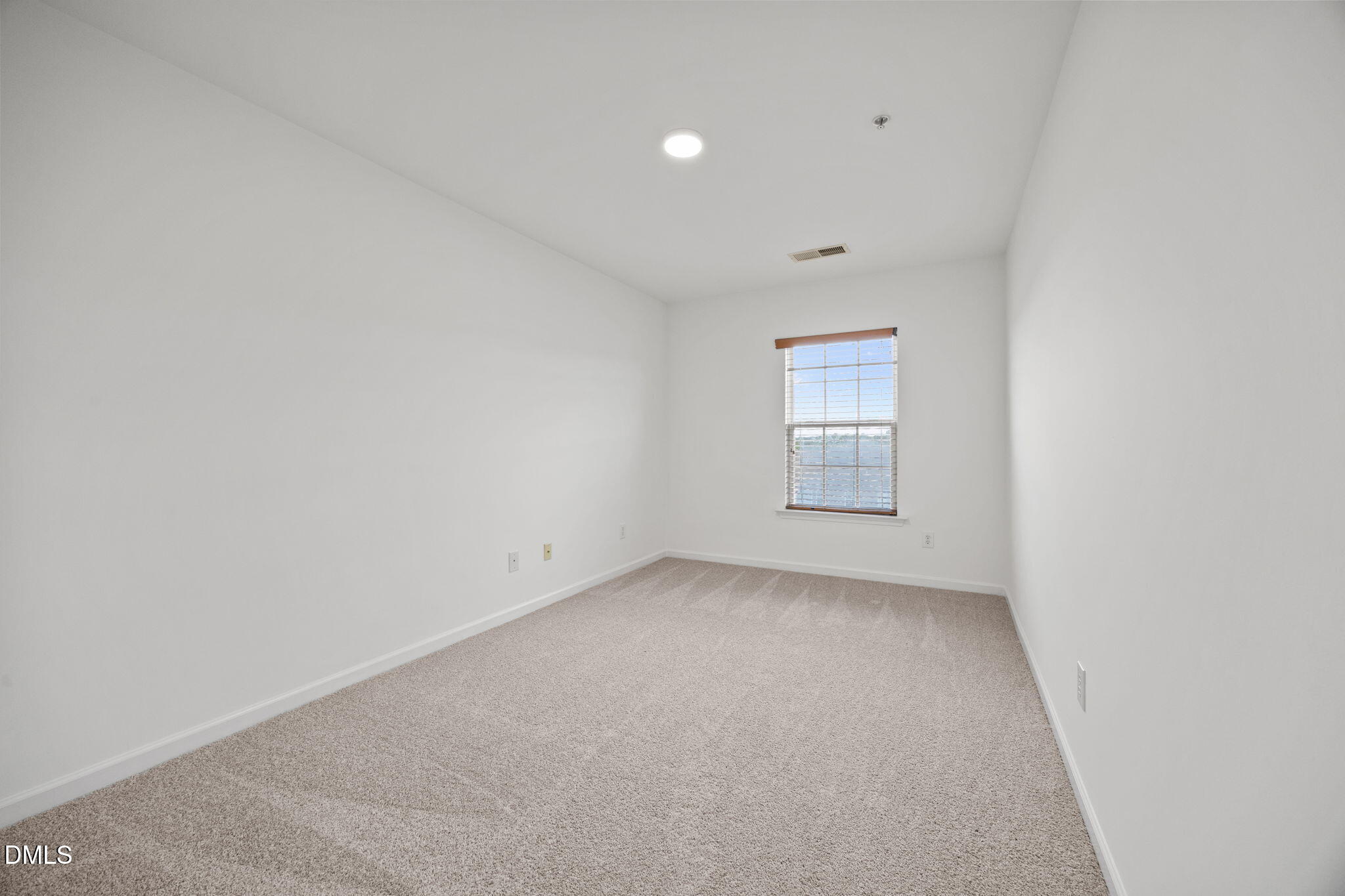 1111 Consortium Drive, Unit 109 Raleigh, NC 27603 - Photo 9 of 30 a view of an empty room with a window