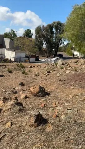 a view of dirt road with a building in the background