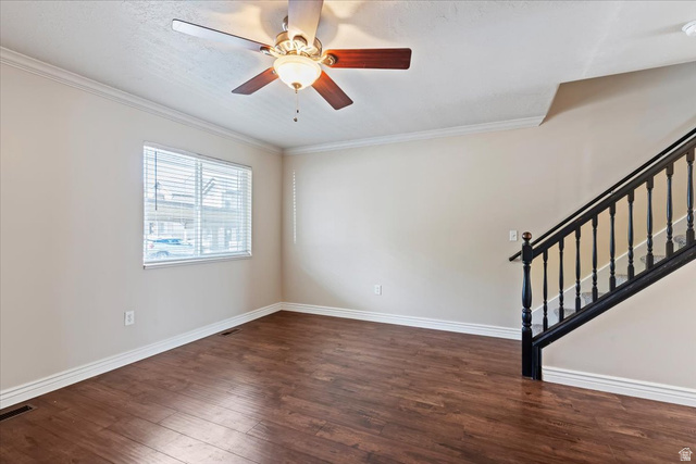 2350 South Highway 89, Unit 4 Perry, UT 84302 - Photo 5 of 30 Unfurnished room with ceiling fan, dark wood-style flooring, and crown molding